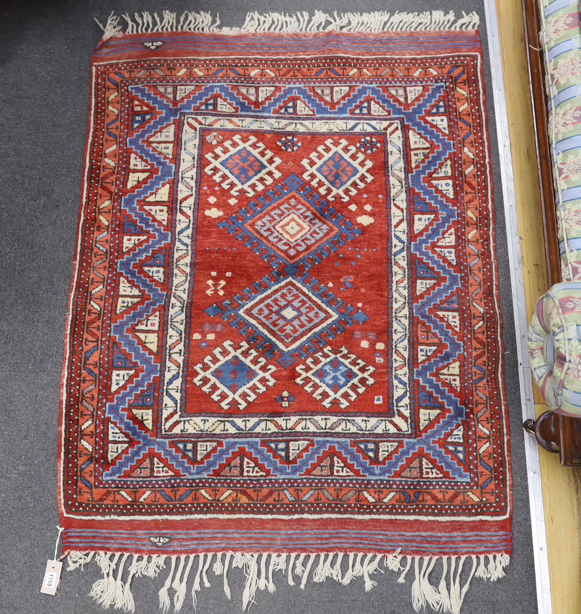 A Turkish red ground rug, 134 x 99cm
